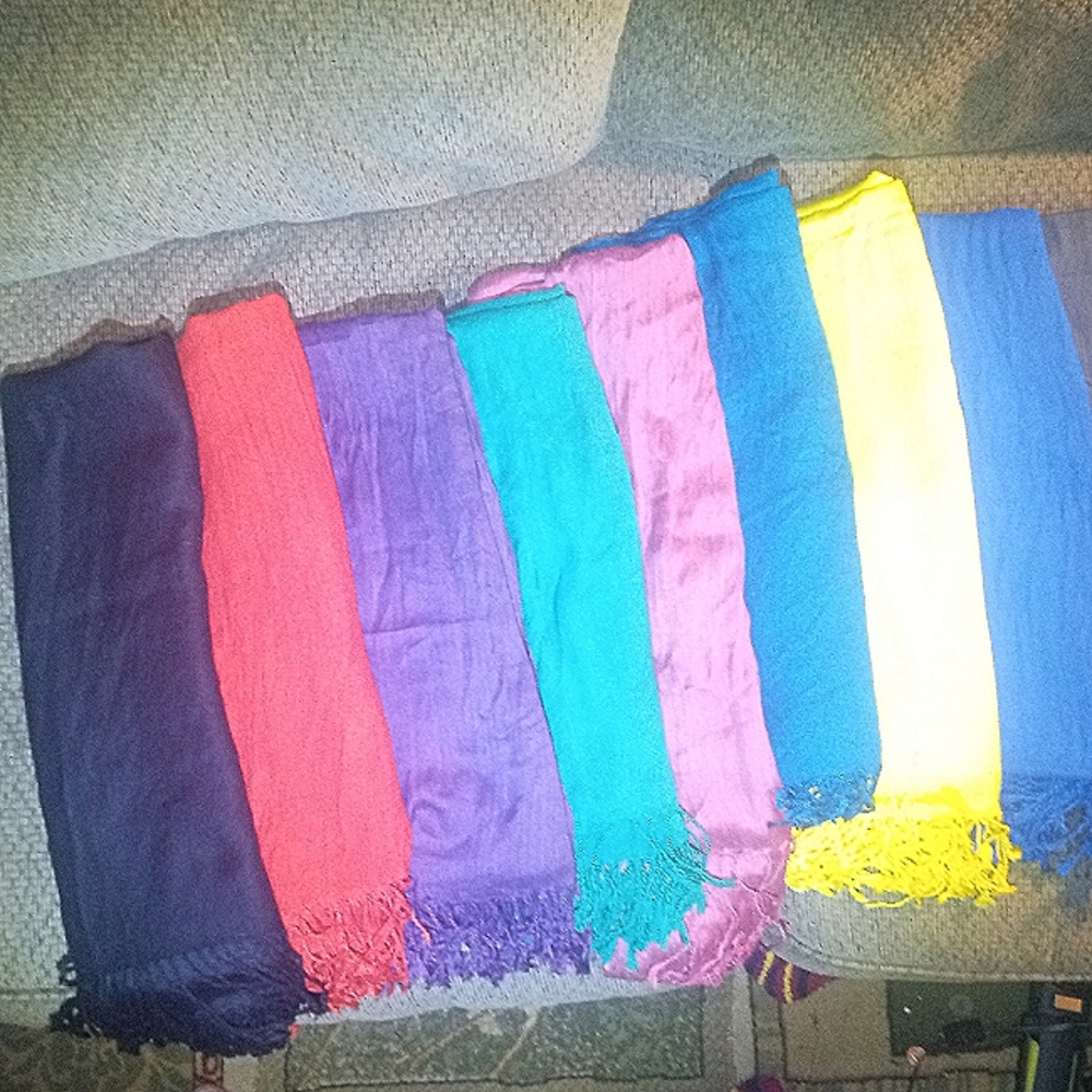 9 solid color.scarves. All are 72" X 24". Light to med-weight.